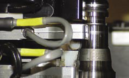Close up view of eddy current probe performing crack test on a bearing spindle